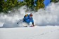A woman smiling while skiing in Colorado.